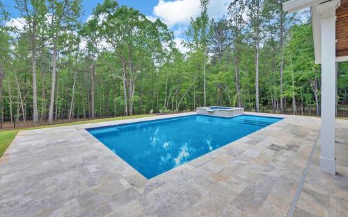 Silver Travertine Coping and Pavers, Tahoe Blue Mini Pebble