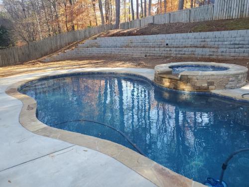 Brown Flagstone and concrete decking, Tropics Blue Mini Pebble