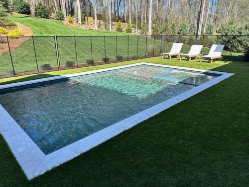 Limestone Coping, turf decking, Tahoe Blue Pebble