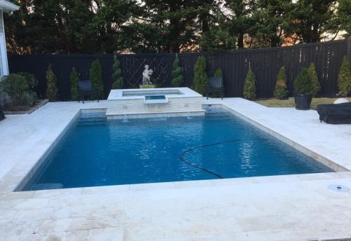 shellbeige limestone coping and decking. Aquacool regular pebble