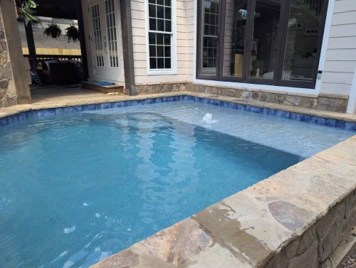 Raised pool/spaFlagstone Coping/wallAqua Blue Mini pebble