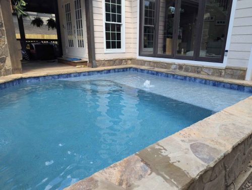 Raised pool/spaFlagstone Coping/wallAqua Blue Mini pebble